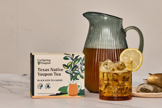 Iced Yaupon Tea packaging with a pitcher and glass of iced tea on a marble surface